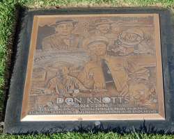 Five years after his death in early 2011, the granite headstone of his grave was replaced with a bronze plaque which shows his various roles in films 